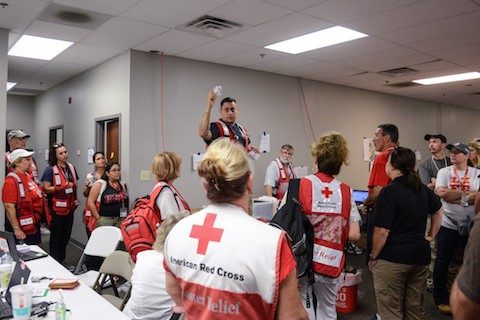 Man speaking to room of Red Cross volunteers